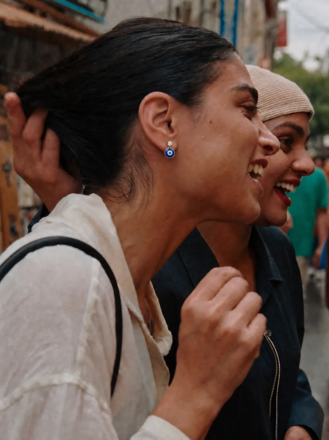 Two friends sharing a candid Bengaluru moment with TITLI earrings