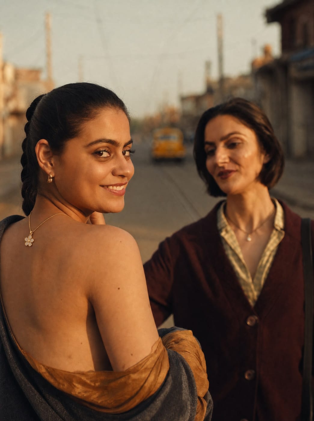 Friends sharing a warm TITLI necklace moment