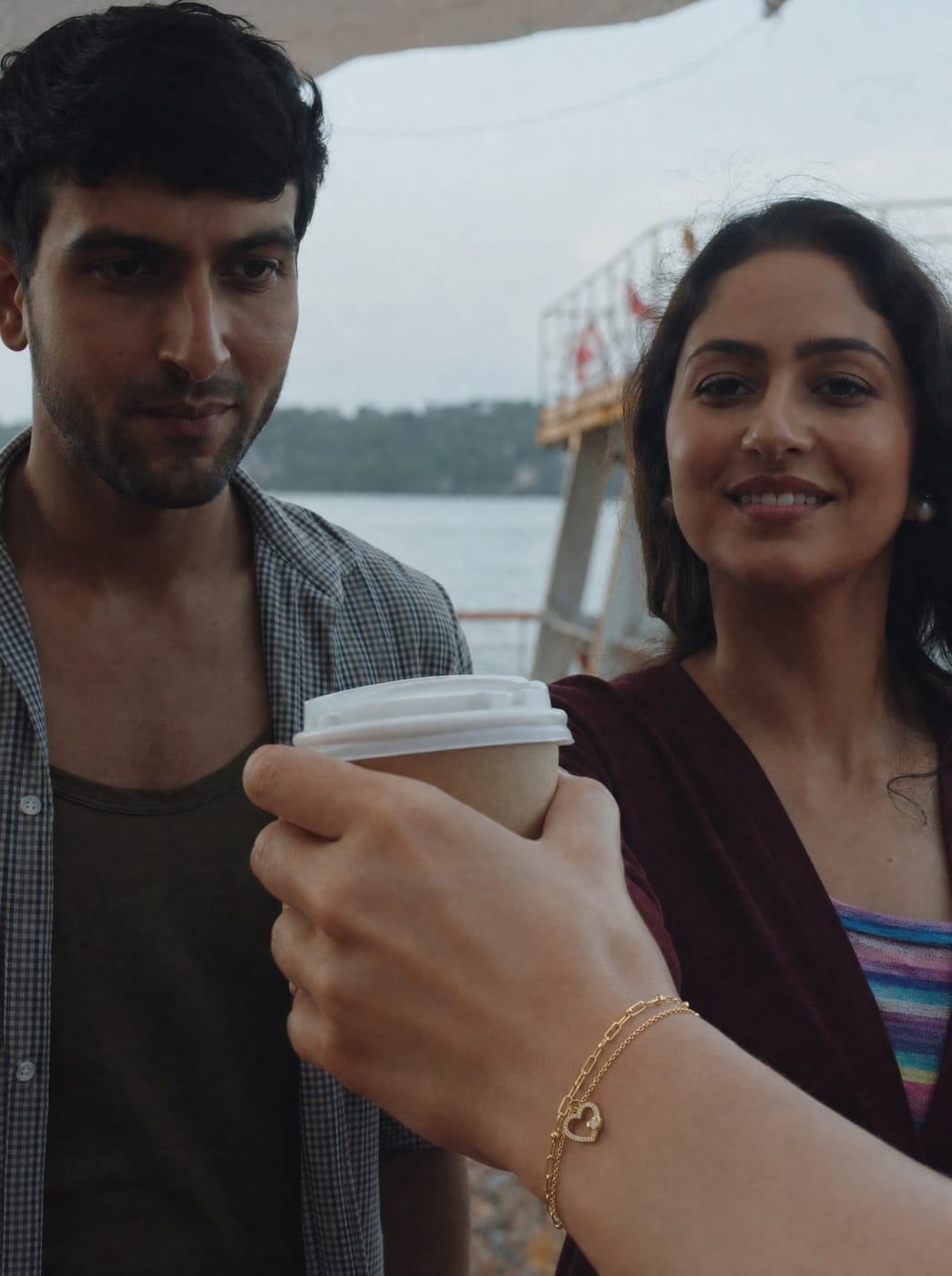 A couple sharing coffee with a TITLI bracelet